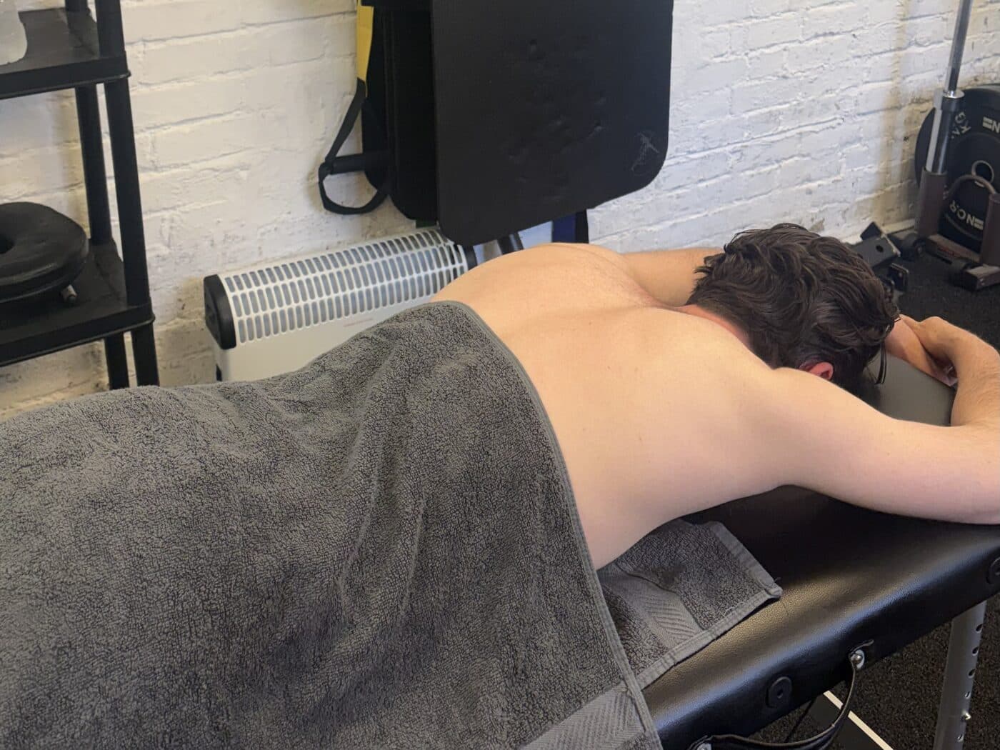 A client lying face down on the treatment table during a massage